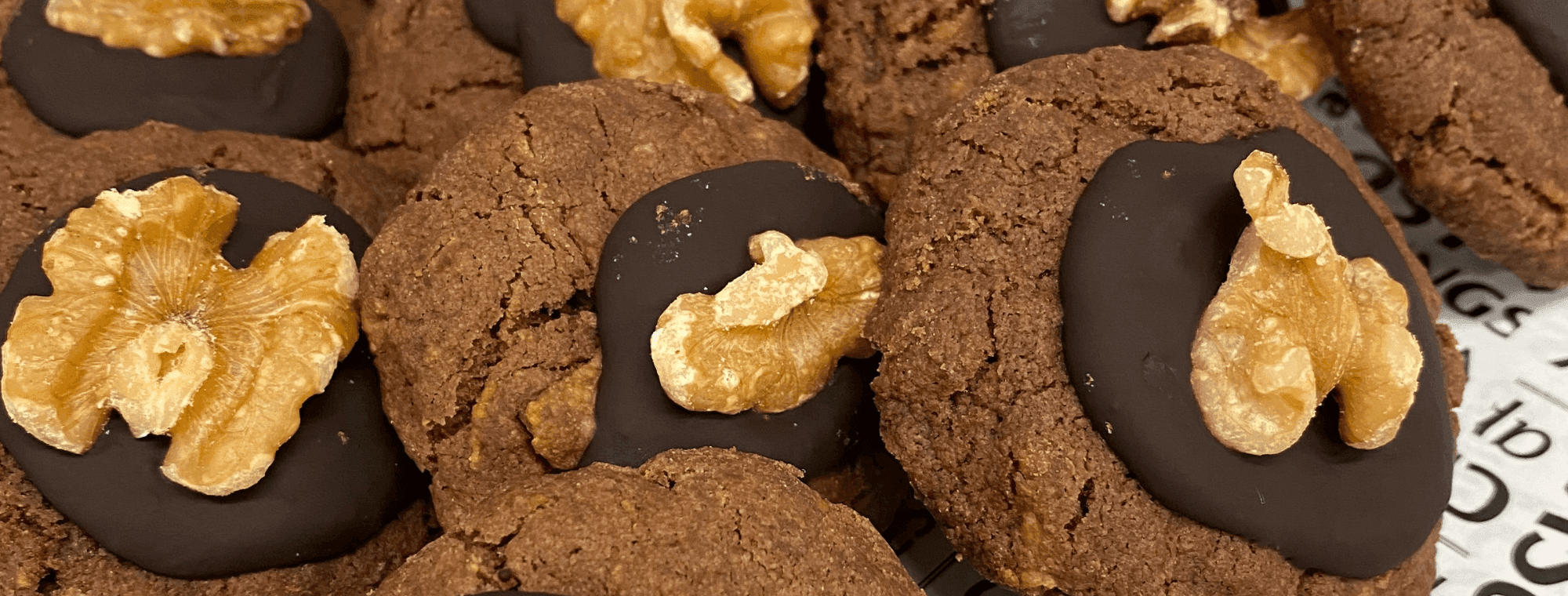 Chocolate cookies with melted chocolate and a walnut on top