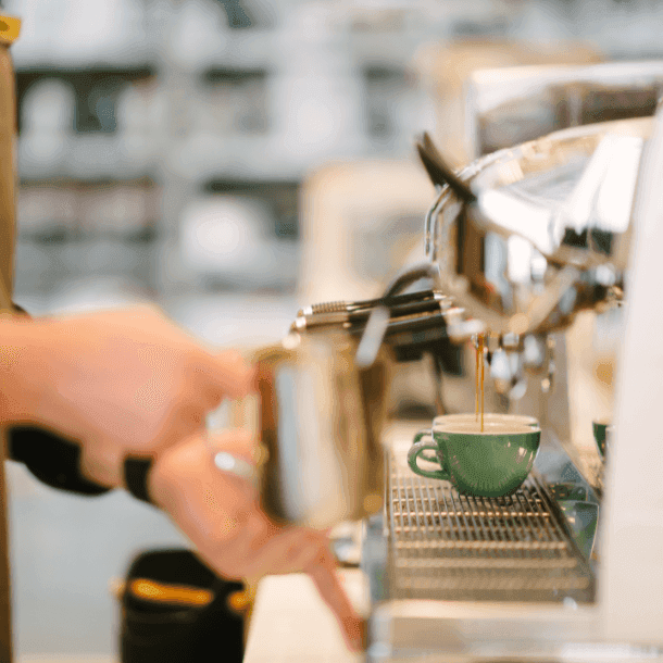 A coffee machine with a green coffee cup 