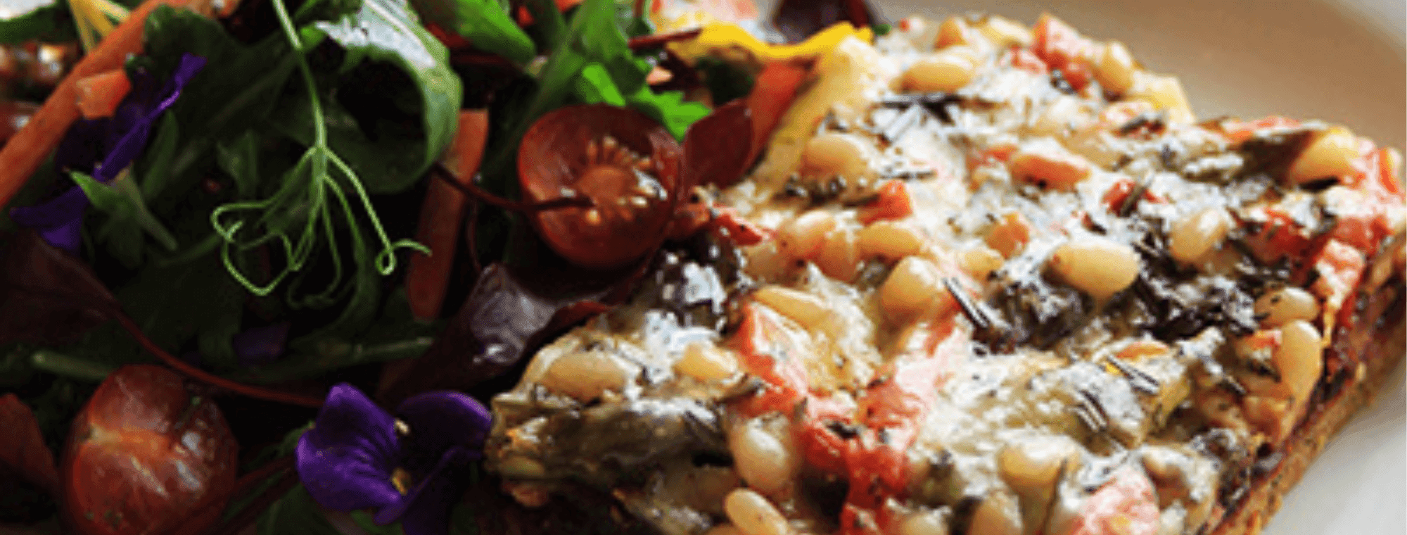Quinoa pizza and salad on a plate